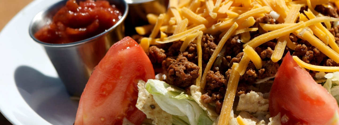 taco salad with cheese, lettuce and tomatoes